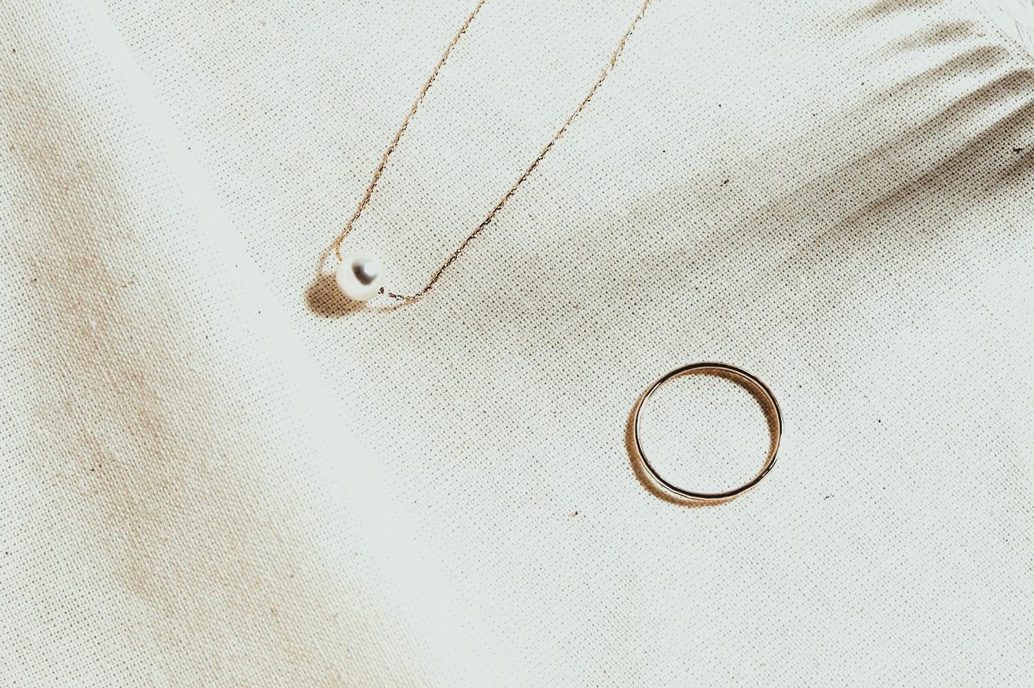 Miradorr design — necklace and ring on linen